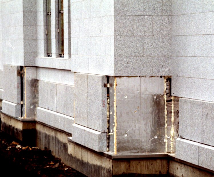 Thicker stone slabs at the base of the walls.