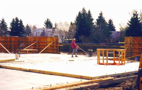 Worker smoothing concrete floor.