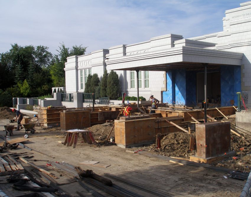 The supporting columns are back in place holding up the portico roof. Additional footings and uprights have been poured.