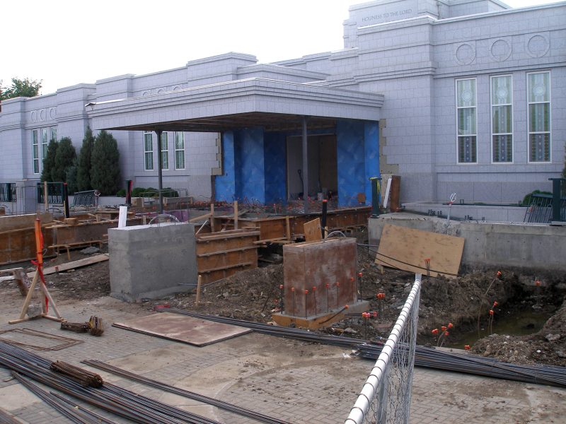 Outer forms have been removed from one poured footing (center, left). Inner forms are ready for the adjacent footing (to its right).