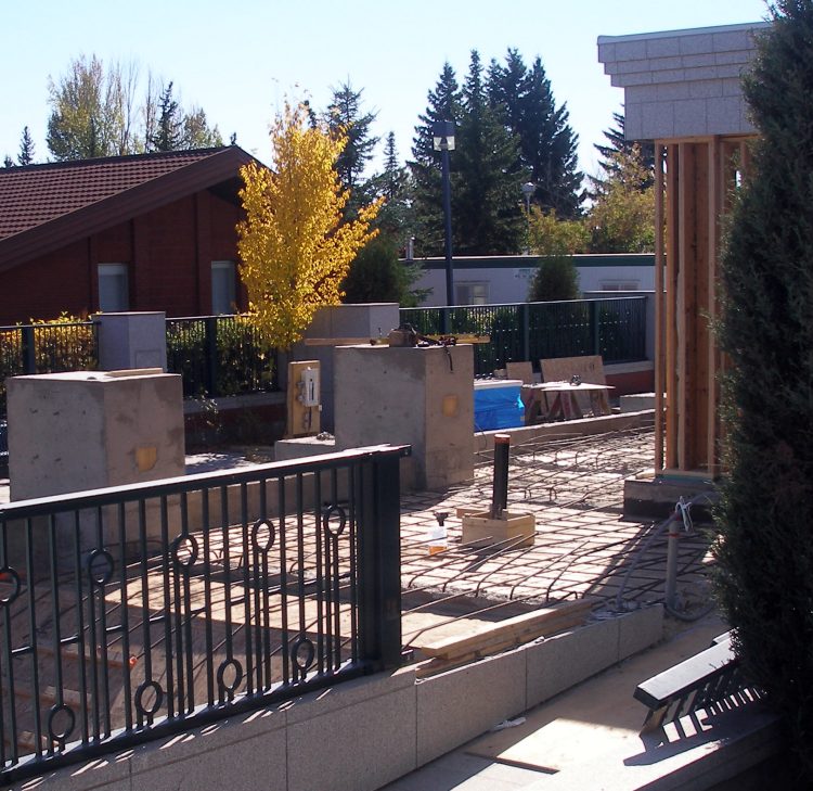 The rebar for the main slab of the platform is being prepared; and the top of the North stairs can be seen behind the fence.