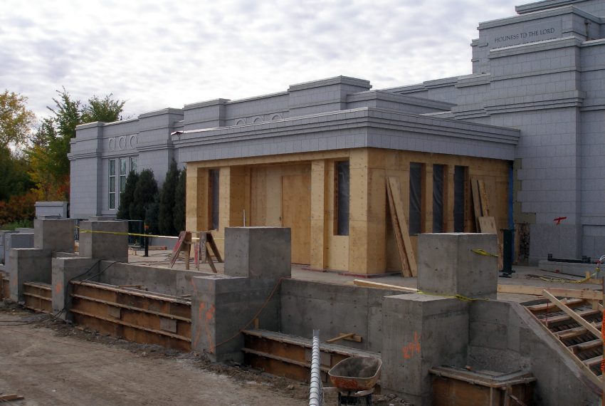 By the Canadian Thanksgiving weekend, the planters along the East wall have been poured. The enclosed portico has a temoprary door and sheeting over the window openings.