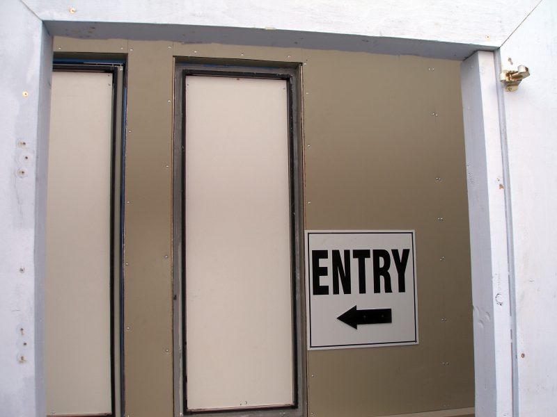 The temporary entryway at the top of the North wheel chair ramp is marked on the unfinished North portico wall exterior.