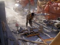 Worker cuts stone for the South stairs, planters, etc. (7 Dec 2011).