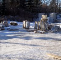 Cut and un-cut stone is readied in the yard for placement (6 Feb 2012).