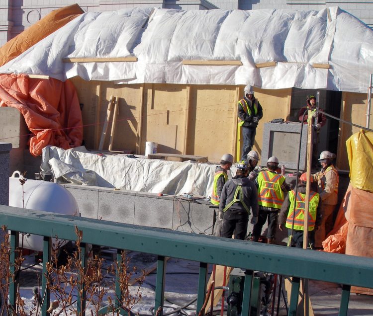 Stone cladding has been set on the planter in front of the platform.