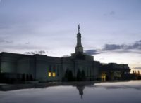 Spire with Moroni statue reflected from a car rooftop in Southeast parking lot.